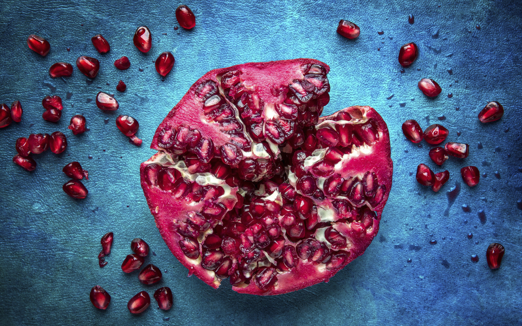 fruit, placer, blue background, garnet, pomegranate grains. 