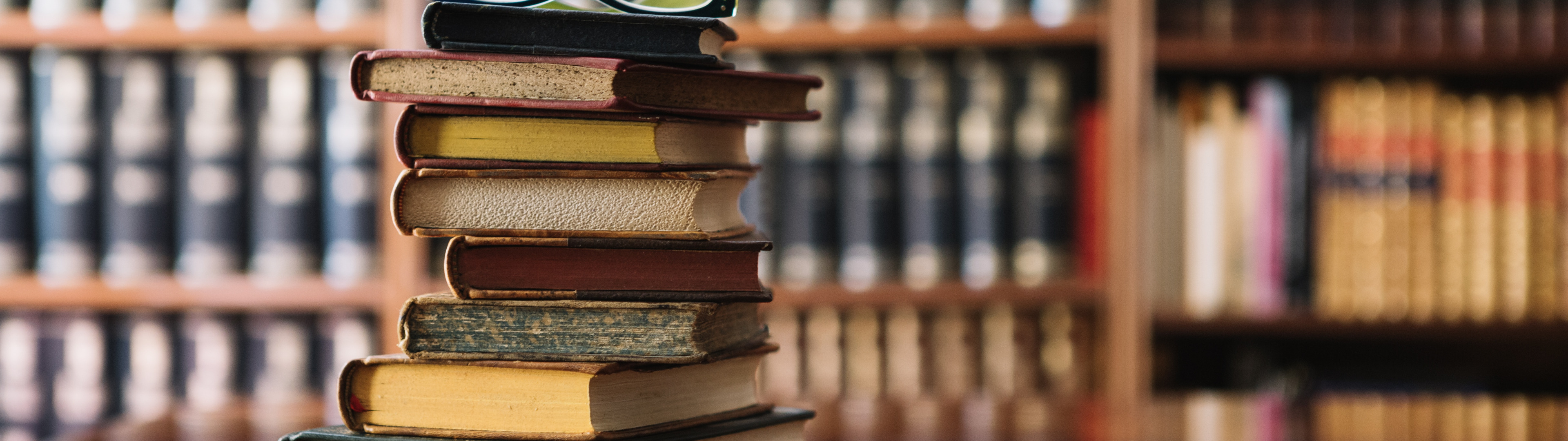 Download wallpaper glasses, table, books, library, section miscellanea