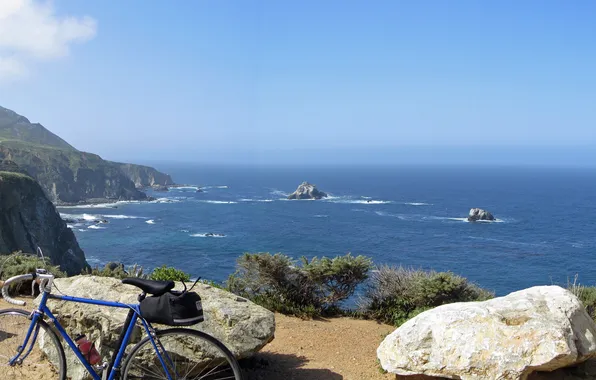 Picture the ocean, shore, bike, halt