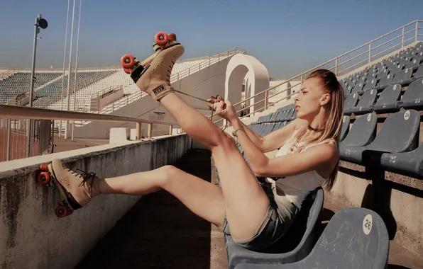 Stadium, women, blonde, sitting, necklace, T-shirt, roller skates, jean shorts