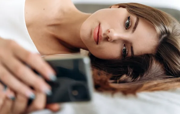 Girl, lies, brown hair, smartphone