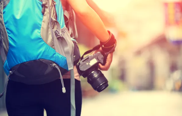 Picture the camera, photographer, backpack