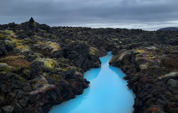 Stone, stream, storm, blue water, gray clouds