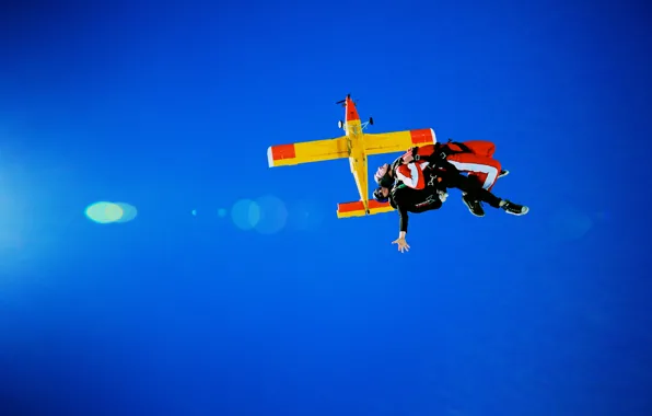 Picture the plane, parachute, container, helmet, sunlight, skydivers, tandem, extreme sports