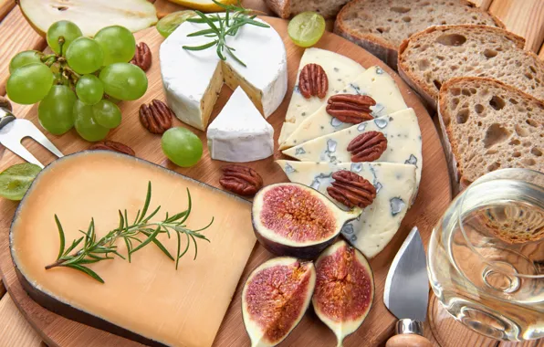 Greens, food, cheese, bread, grapes, nuts, a glass of wine, figs