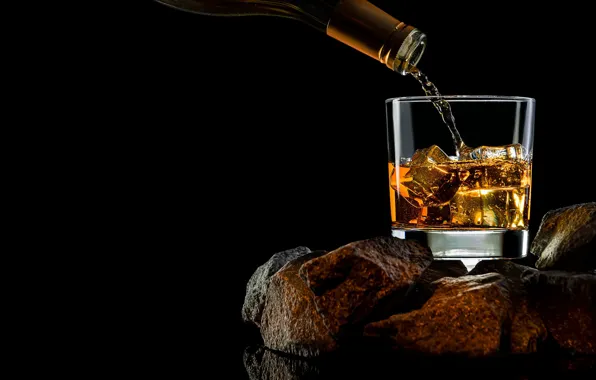 Picture stones, glass, bottle, black background, whiskey
