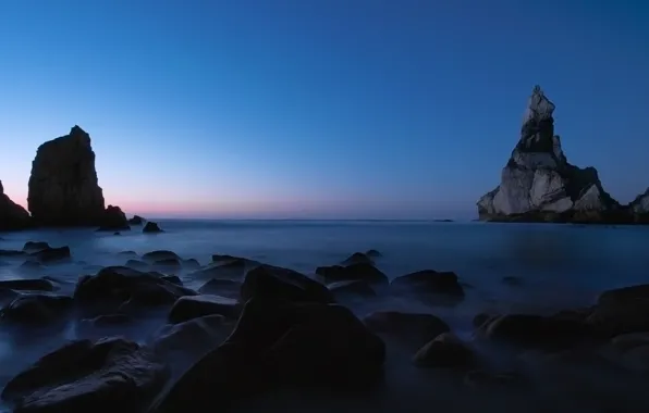 Sea, rocks, twilight