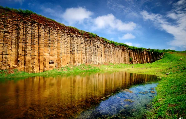 Picture the sky, grass, clouds, rock, lake, stones