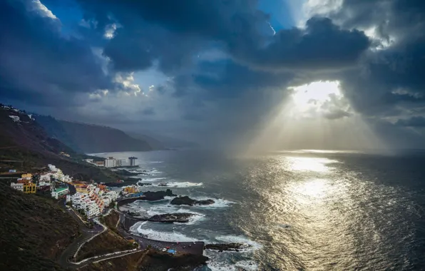 The sky, rays, light, mountains, clouds, the city, the ocean, coast