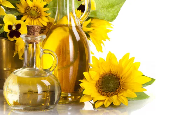 Leaves, sunflowers, oil, white background, bottles