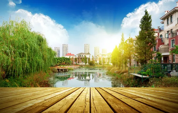 The sky, water, the sun, clouds, trees, the city, the bridge