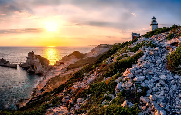 Picture sea, the sky, the sun, rocks, lighthouse, the evening