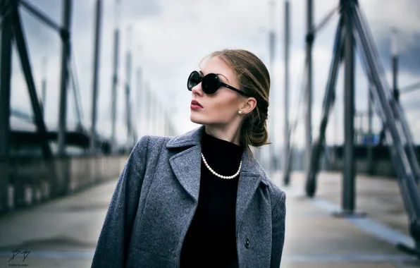 Glasses, beads, brown hair, coat