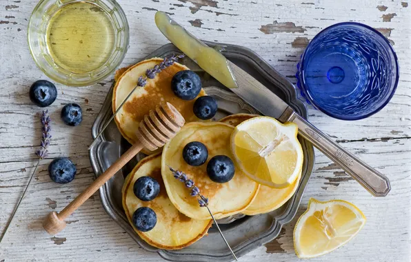 Berries, lemon, blueberries, knife, glasses, lavender, pancakes