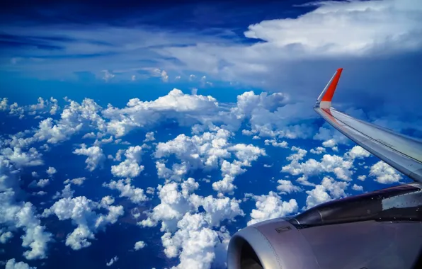 The sky, clouds, wing, the plane, under the wing of the plane