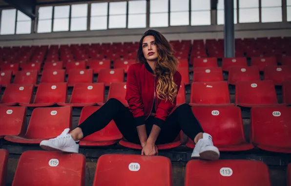 Stadium, women, brunette, sitting, jacket, sneakers, red jackets, no socks