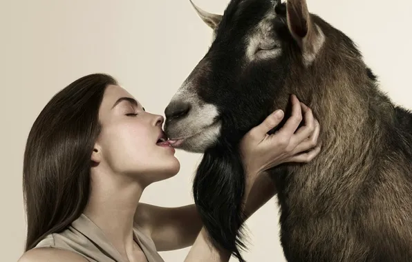 Girl, goat, kiss