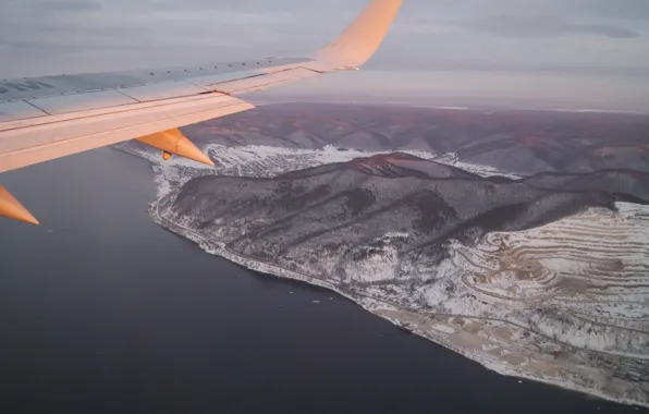 The sky, sunset, mountains, the plane, river, wing