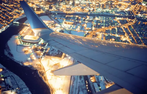 Picture the city, lights, the plane, wing
