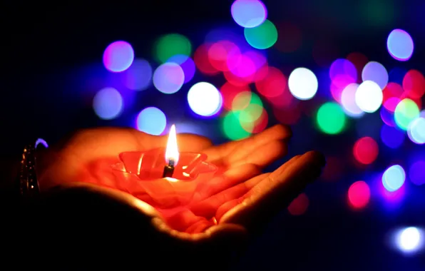Picture lights, candle, hands