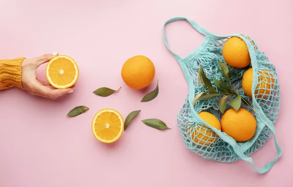 Leaves, mesh, hand, oranges, fruit, pink background, the consumer, composition