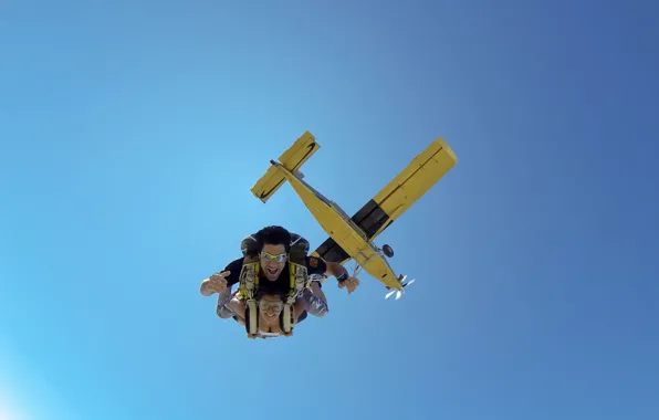 The sky, smile, the plane, glasses, parachute, container, skydivers, tandem