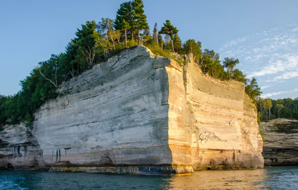 Picture the sky, trees, rock, lake, shore