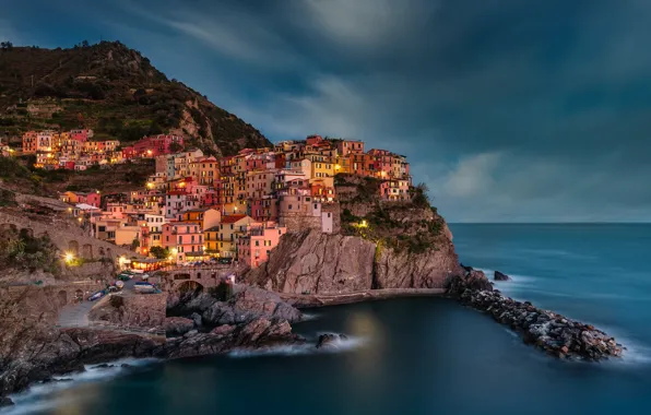 Sea, clouds, the city, lights, stones, rocks, shore, building