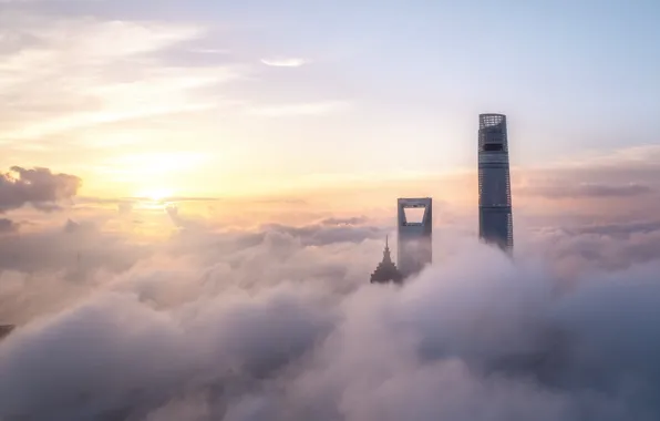 The sky, the sun, clouds, the city, fog, dawn, building, height