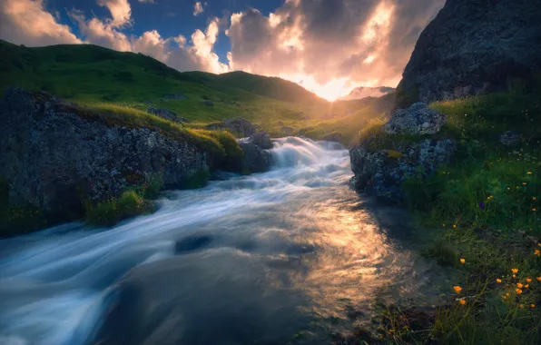 Picture the sky, the sun, mountains, river, rocks, shore, waterfall, stream
