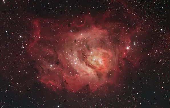 In the constellation Sagittarius, The Lagoon Nebula, a giant interstellar cloud