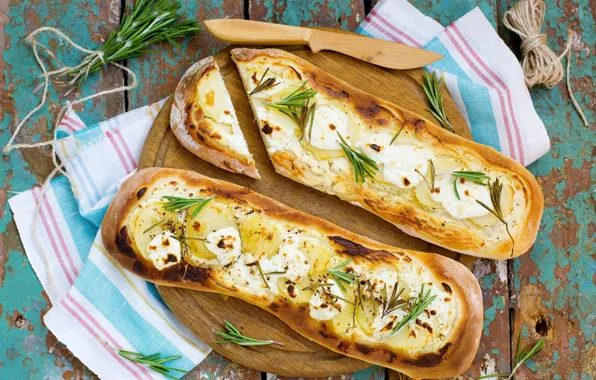 Cheese, bread, wood, napkin, spices, rosemary, potatoes, cutting Board