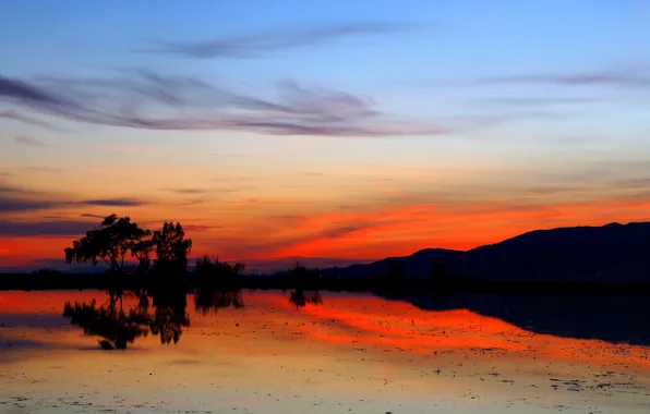 The sky, clouds, trees, sunset, mountains, lights, lake, glow
