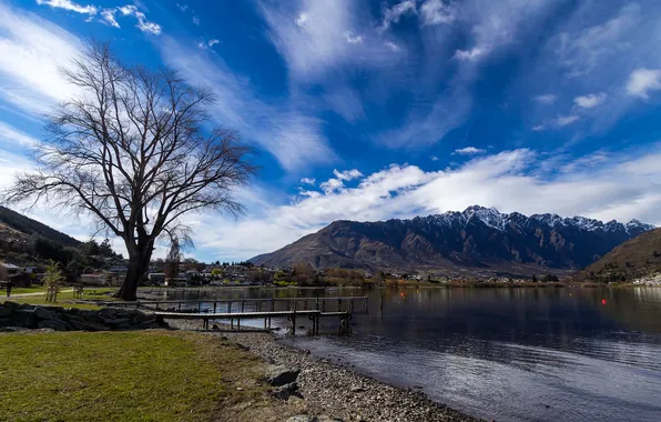 The sky, clouds, mountains, lake, tree, the bridge, the village