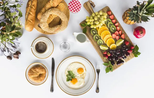 Coffee, oranges, cookies, strawberry, grapes, pineapple, scrambled eggs, cakes