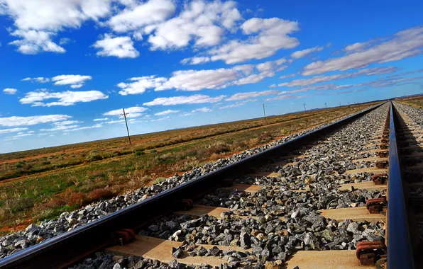 Picture the sky, clouds, the steppe, rails, railroad, sleepers, crushed stone
