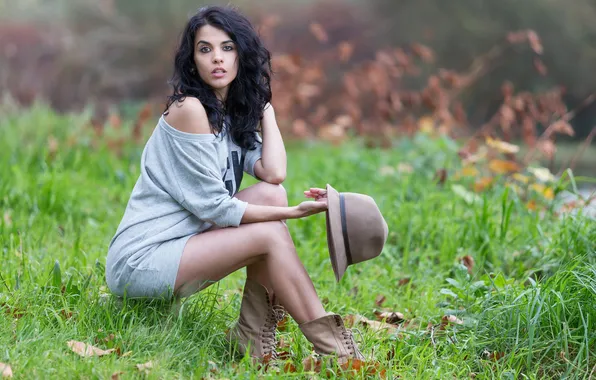 Green grass, hat, beautiful brunette, summer day, photo shoot in nature