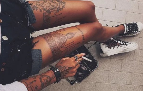 Tattoo, cigarette, bracelet, handbag, sneakers, ring, slender legs, tattoos on the arm