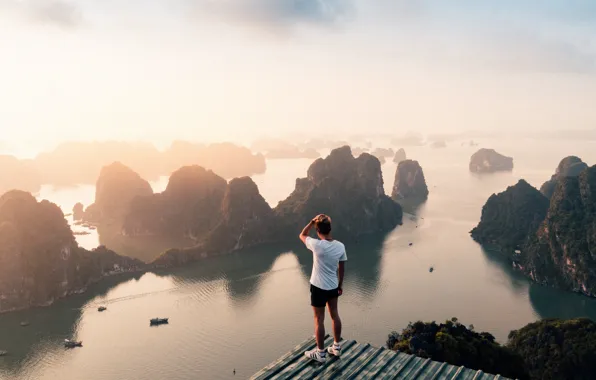 The sky, water, the sun, rocks, people, height, ships, male