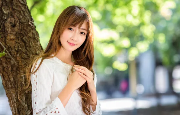 Asian, on the street, beautiful girl, blurred background, the trunk of the tree, folded hands, …