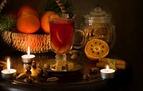 Candle, oranges, spices, mulled wine
