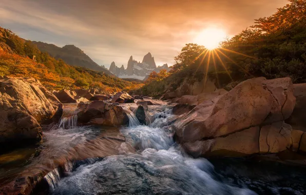 The sun, rays, mountains, river, stones, dawn, waterfall
