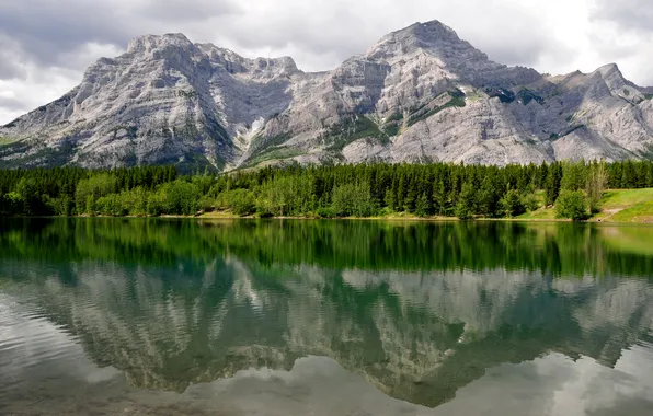 The sky, clouds, trees, mountains, lake