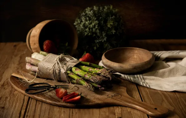 Greens, berries, the dark background, table, strawberry, newspaper, dishes, bowl