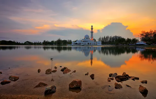 The sky, clouds, trees, lake, stones, mosque, the minaret