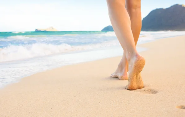 Sea, sand, foot on the beach