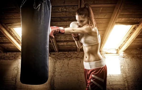 Picture woman, boxing, boxing bag to hit