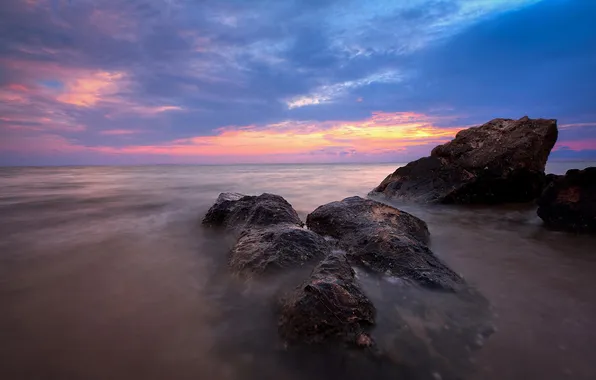 Clouds, sunset, stones, the ocean