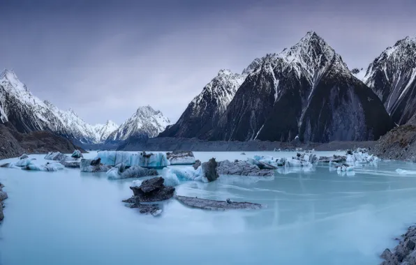 Winter, snow, mountains, lake, stones, rocks, shore, the slopes