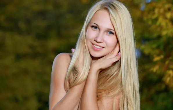 blonde white background slight smile